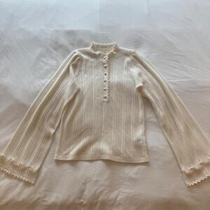 Sezane cream knit sweater with vertical ribbed texture